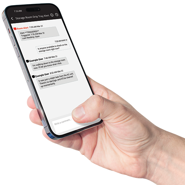 Hand holding a smartphone displaying the Room Alert Account mobile app interface with menu options and monitoring data, demonstrating the mobile user experience for facility monitoring.